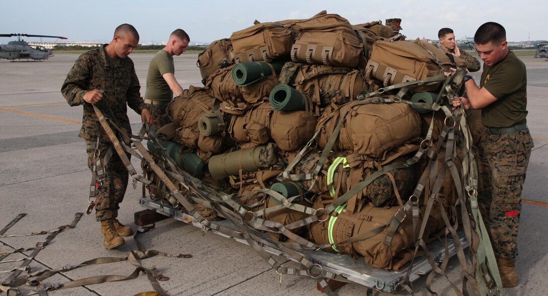 Marines secure gear onto a pallet Nov. 10 at Marine Corps Air Station Futenma during preparation for a humanitarian assistance and disaster relief mission to the Philippines. A forward command element and humanitarian assistance survey team, led by Brig. Gen. Paul Kennedy, the deputy commander of III Marine Expeditionary Force and the commanding general of the 3rd Marine Expeditionary Brigade, are deploying to the Philippines from Okinawa to provide an initial assessment on the support required.  The initial focus of U.S. relief efforts includes surface maritime search and rescue (SAR), airborne maritime SAR, medium-heavy helicopter lift support, fixed-wing lift support and logistics enablers. MCAS Futenma is a mission ready air station capable of continuous aviation and base operating support for tenant organizations and follow-on U.S., Allied, and United Nations forces during combat or contingency operations in the Western Pacific Theater of operations, to include U.S. Pacific Command, Marine Corps Forces Pacific and Marine Corps Installations Pacific.