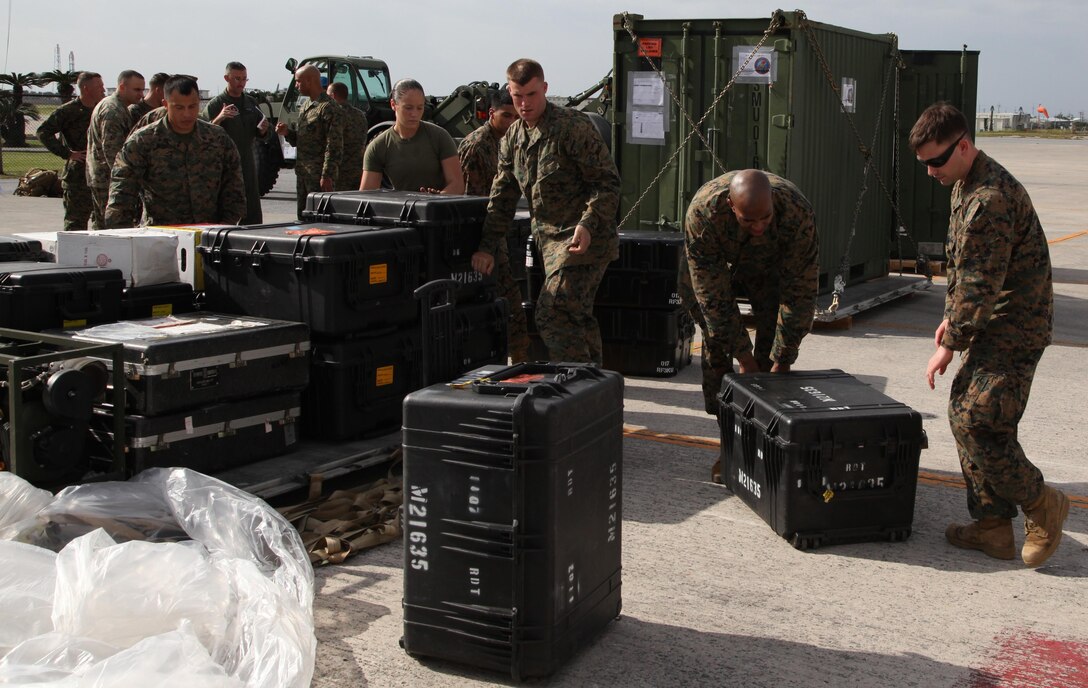 Marines preparing to depart for the Philippines stack their gear on a pallet Nov. 10 at Marine Corps Air Station Futenma, Okinawa, Japan. Approximately 90 U.S. Marines and Sailors from 3rd Marine Expeditionary Brigade departed on two KC-130J Hercules aircraft. The initial focus of U.S. relief efforts includes surface maritime search and rescue (SAR), airborne maritime SAR, medium-heavy helicopter lift support, fixed-wing lift support and logistics enablers. The aircraft are with Marine Aerial Refueler Transport Squadron 152, Marine Aircraft Group 36, 1st Marine Aircraft Wing, III Marine Expeditionary Force. MCAS Futenma is a mission ready air station capable of continuous aviation and base operating support for tenant organizations and follow-on U.S., Allied, and United Nations forces during combat or contingency operations in the Western Pacific Theater of operations, to include U.S. Pacific Command, Marine Corps Forces Pacific and Marine Corps Installations Pacific.
