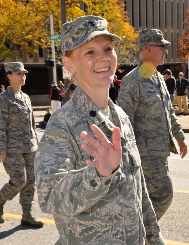 Director of Staff of the 932nd Airlift Wing, Lt. Col. Michelle Huffman, waves to the crowd during the annual Veterans Day parade November 9th, 2013, downtown St. Louis. Huffman expressed appreciation for the support of the community extended the wing and the veterans of various wars and branches of services.  (U.S. Air Force Photo by Staff Sgt. Amber Hodges)