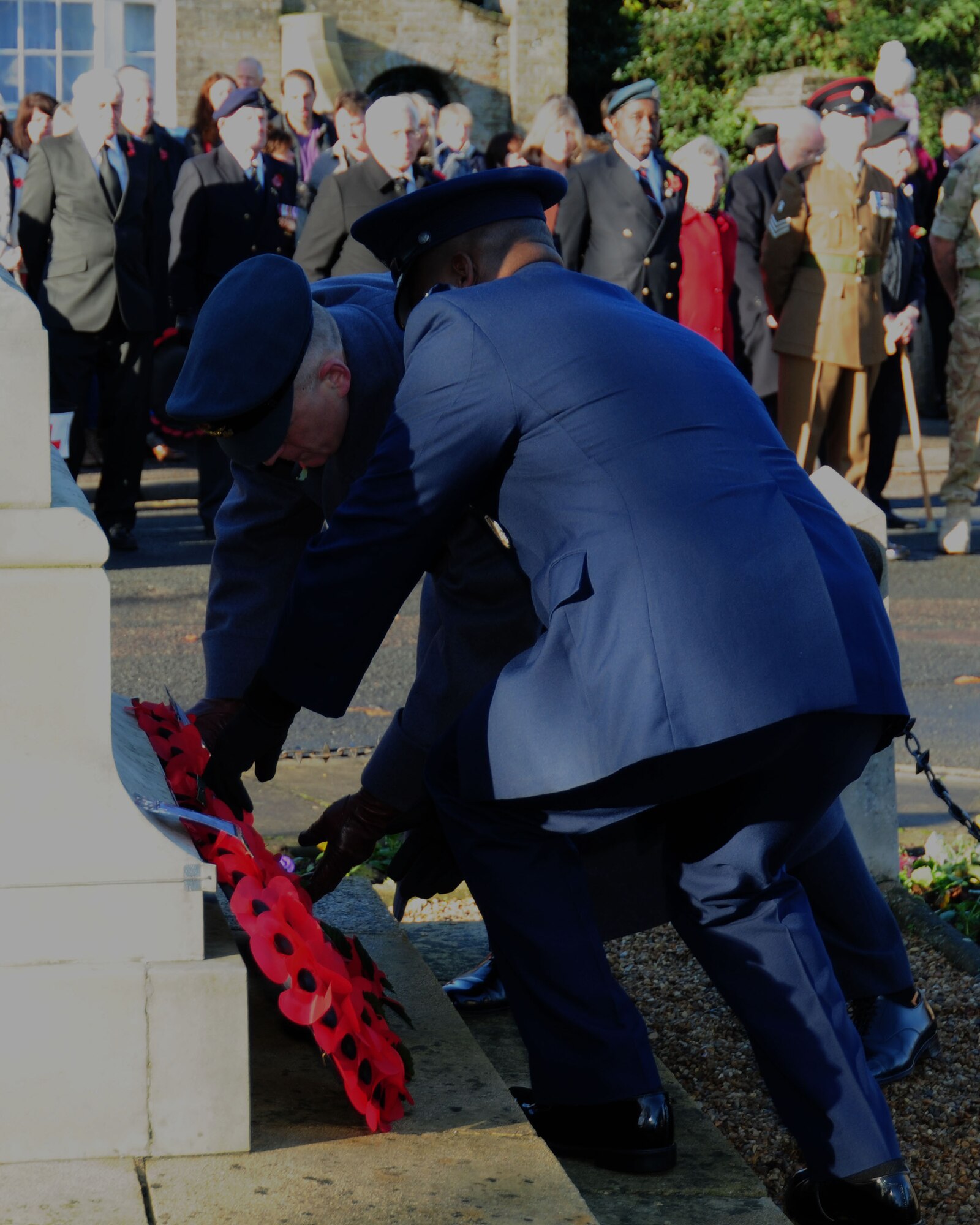 Royal Air Force Sq. Ldr. Richard Fryer, left, the RAF commander of RAF Mildenhall, and U.S. Air Force Col. Earl Scott, 100th Maintenance Group commander, lay a wreath during a Remembrance Day ceremony Nov. 10, 2013, in Mildenhall in Suffolk, England. The day was originally named Armistice Day after World War I, which ended at the 11th hour on the 11th day of the 11th month in 1918. The day was changed to Remembrance Day after World War II to honor all of the men and women who serve. (U.S. Air Force photo by Karen Abeyasekere/Released)