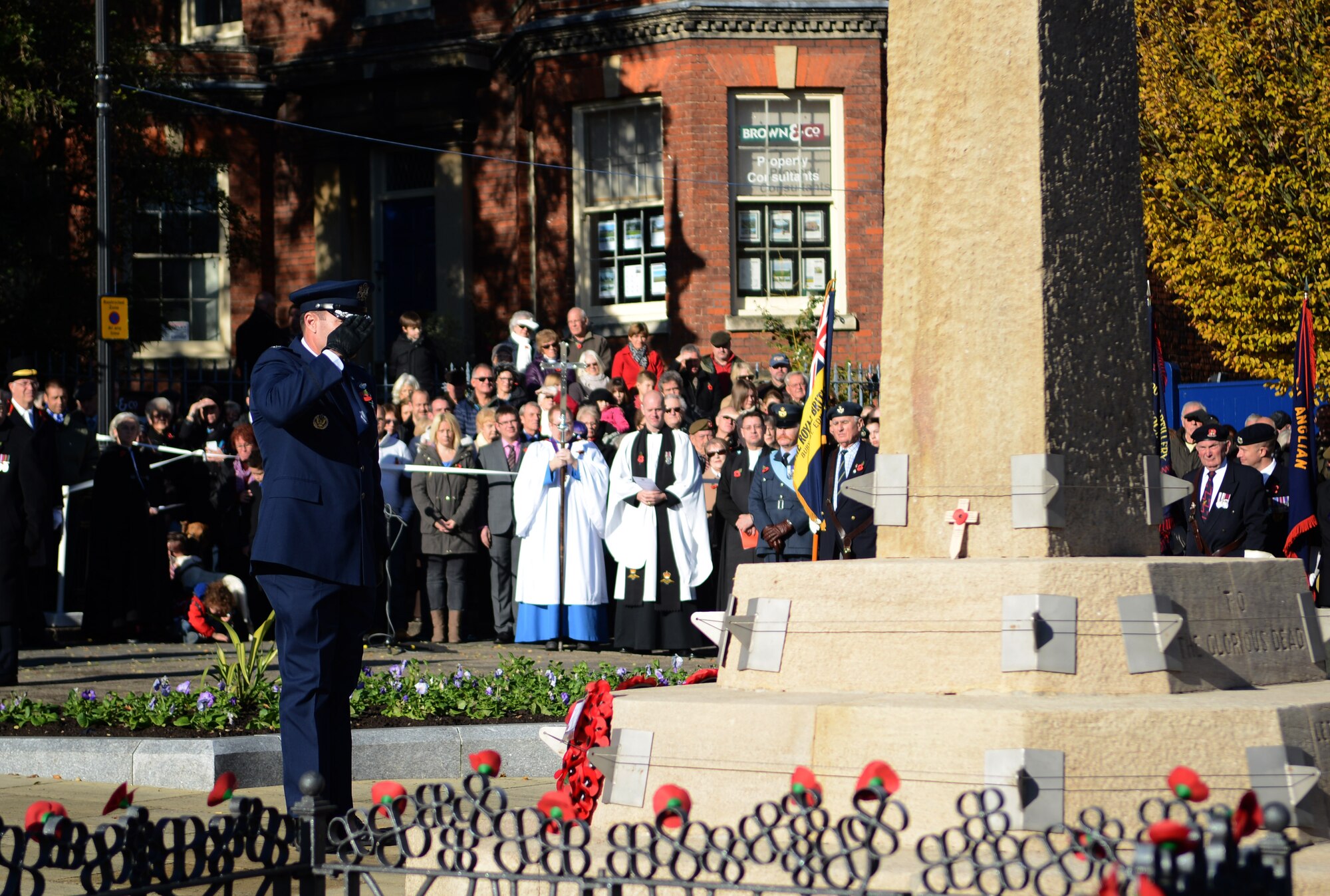 U.S. Air Force Col. Kenneth T. Bibb Jr., 100th Air Refueling Wing commander, salutes after laying a wreath during a Remembrance Day ceremony Nov. 10, 2013, in Bury St. Edmunds in Suffolk, England. The poppy was chosen as the symbol of remembrance because many British soldiers lost their lives in the poppy fields of Flanders, Belgium, during World War I. The day was originally named Armistice Day after World War I, which ended at the 11th hour on the 11th day of the 11th month in 1918. The day was changed to Remembrance Day after World War II to honor all of the men and women who serve. (U.S. Air Force photo by Airman 1st Class Dillon Johnston/Released)