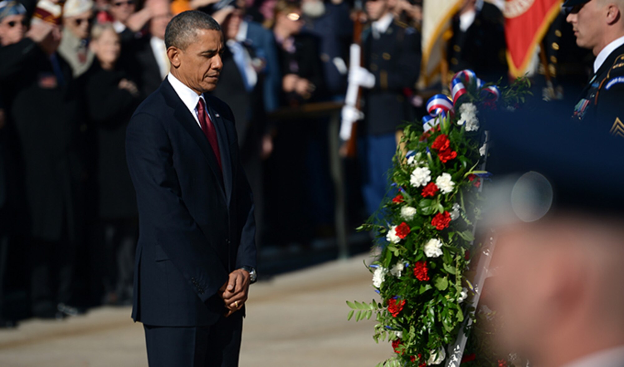 President Barack Obama pauses before a wreath he placed Nov. 11, 2013, at the Tomb of the Unknown Soldier during a Veterans Day ceremony at Arlington National Cemetery in Arlington, Va. Vice President Joe Biden stands behind the president at left. (Department of Defense photo/EJ Hersom)