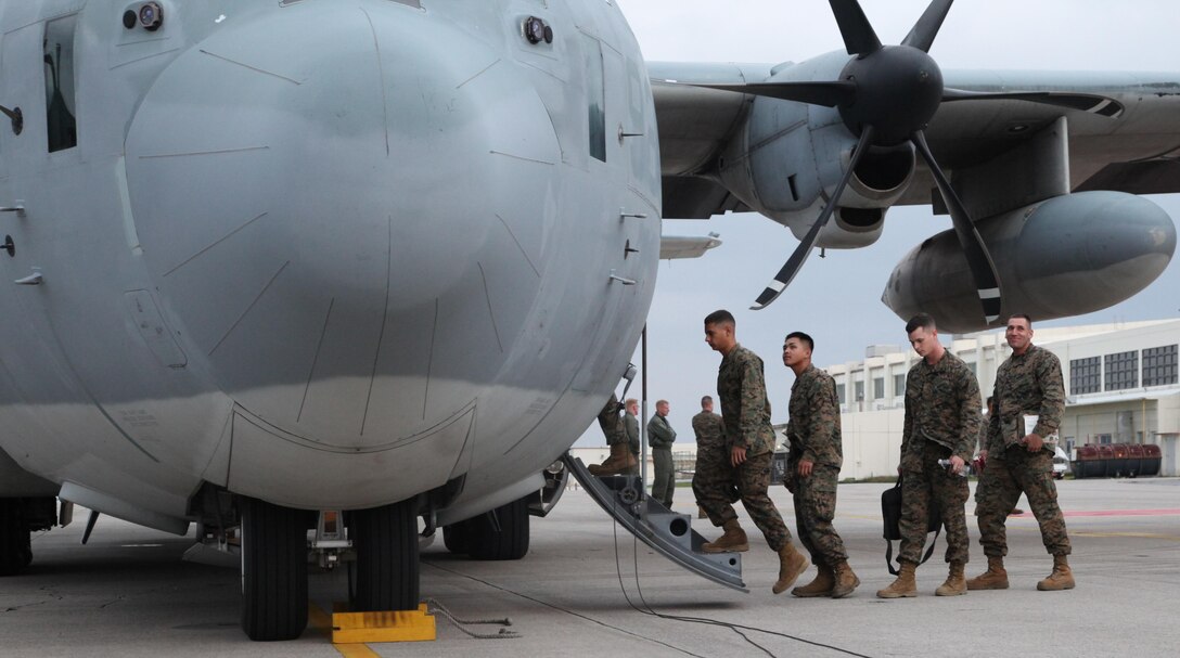 Marines board a KC-130J Hercules aircraft Nov. 11 at Marine Corps Air Station Futenma, Okinawa, Japan, to depart for humanitarian assistance and disaster relief operations in the Philippines following Super Typhoon Haiyan. The initial focus of U.S. relief efforts includes surface maritime search and rescue (SAR), airborne maritime SAR, medium-heavy helicopter lift support, fixed-wing lift support and logistics enablers. The aircraft is with Marine Aerial Refueler Transport Squadron 152, Marine Aircraft Group 36, 1st Marine Aircraft Wing, III Marine Expeditionary Force. The Marines are with III MEF. (U.S. Marine Corps photo by Lance Cpl. David N. Hersey/Released)
