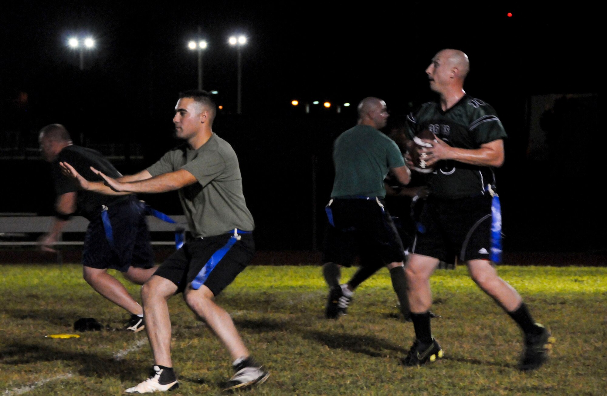 A member from the 36th Civil Engineer Squadron prepares to pass the ball to a teammate during an intramural football game against the 94th Army Air and Missile Defense Command Nov. 6, 2013, on Andersen Air Force Base, Guam. The 36th CES defeated the 94th AAMDC 18-14. (U.S. Air Force photo by Airman 1st Class Amanda Morris/Released)