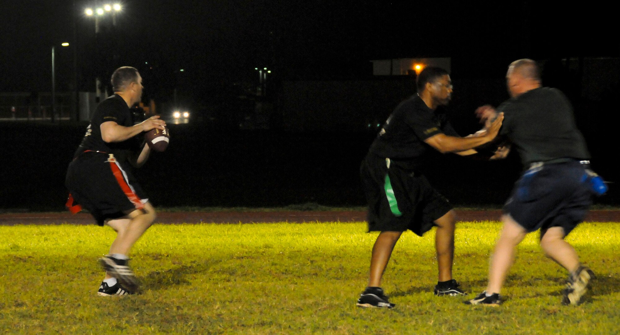 A member from the 94th Army Air and Missile Defense Command looks for open receivers during an intramural football game against the 36th Civil Engineer Squadron Nov. 6, 2013, on Andersen Air Force Base, Guam. The 36th CES defeated the 94th AAMDC 18-14. (U.S. Air Force photo by Airman 1st Class Amanda Morris/Released)