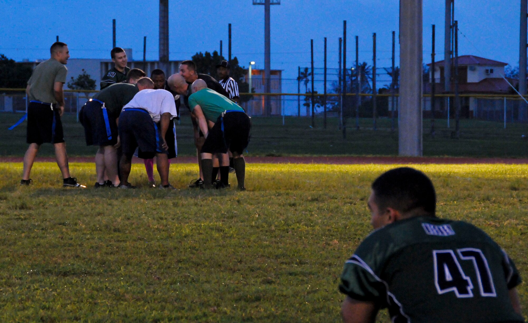 Members of the 36th Civil Engineer Squadron intramural flag football team huddle to decide a game plan for the game against the 94th Army Air and Missile Defense Command Nov. 6, 2013, on Andersen Air Force Base, Guam. The 36th CES defeated the 94th AAMDC 18-14. (U.S. Air Force photo by Airman 1st Class Amanda Morris/Released)