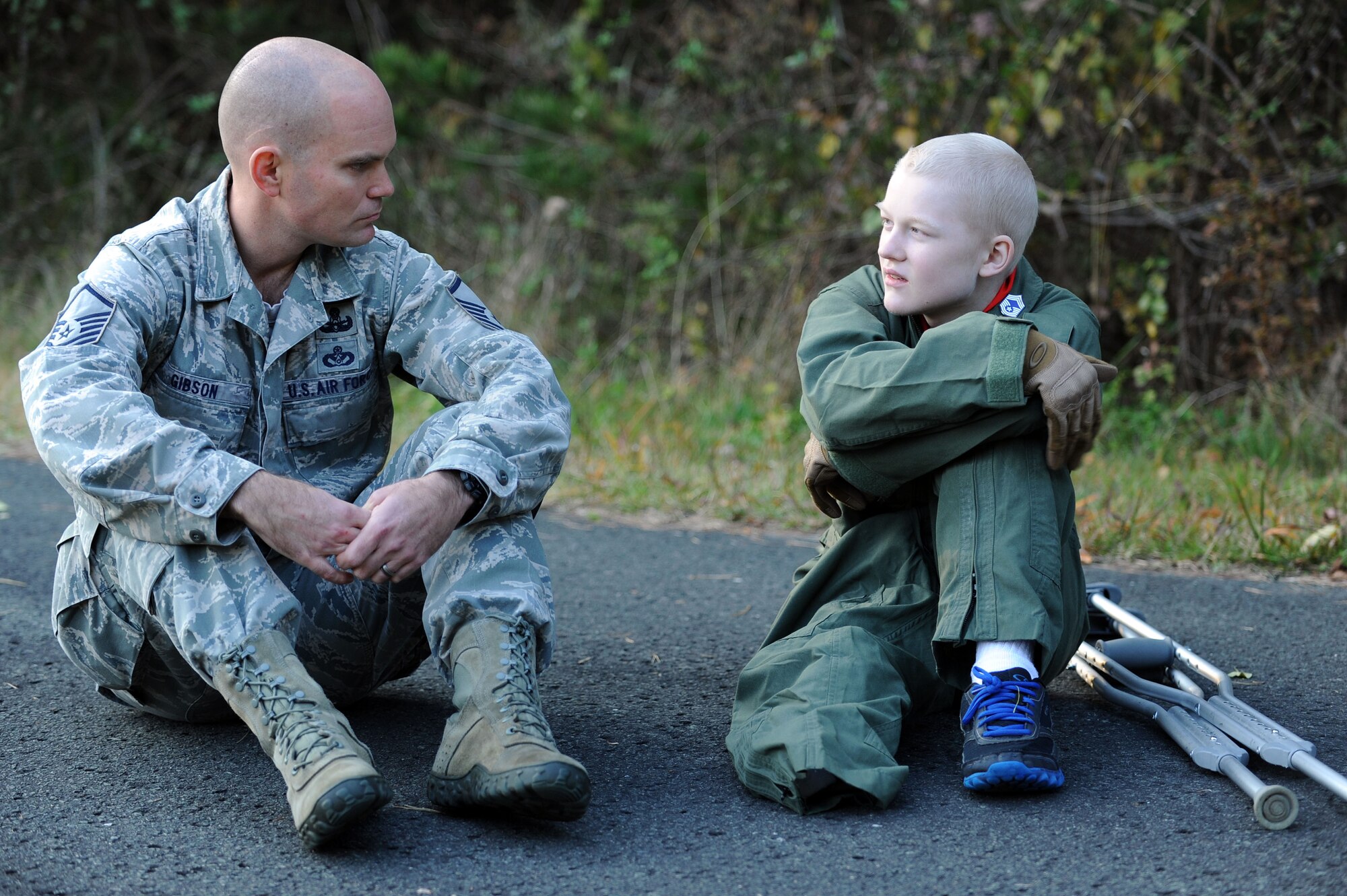 Master Sgt. Cary Gibson, 35th Civil Engineer Squadron explosive ordnance disposal flight chief, takes a moment to mentor 17-year-old Jonah Skrove at Misawa Air Base, Japan, Nov. 6, 2013. After being diagnosed with osteosarcoma, Jonah was granted a wish by the Make-A-Wish Foundation. Instead of wishing to meet a famous actor or sports player, Jonah wished to see his brother who is stationed here. Members of several base agencies, like EOD, took time out of their schedule to share their mission with the Skrove family. (U.S. Air Force photo by Staff Sgt. Alyssa C. Wallace/released)