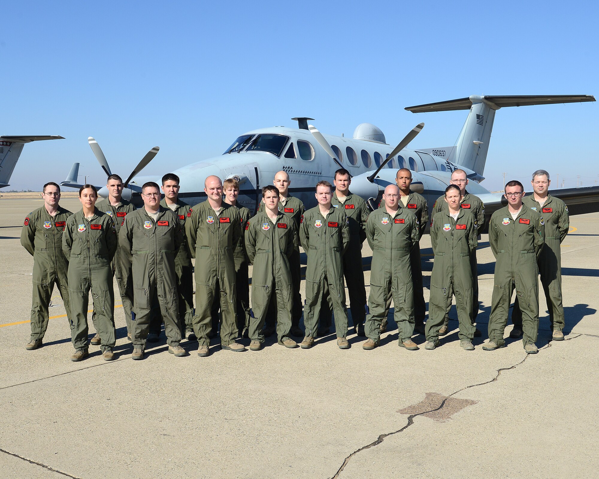 Members of the 427th Reconnaissance Squadron pose for a picture in front of a MC-12W liberty aircraft on Beale Air Force Base, Calif., Oct. 31, 2013. The pictured crew collectively has more than 20,000 combat hours flying the liberty. (U.S. Air Force photo by John Schwab/Released)