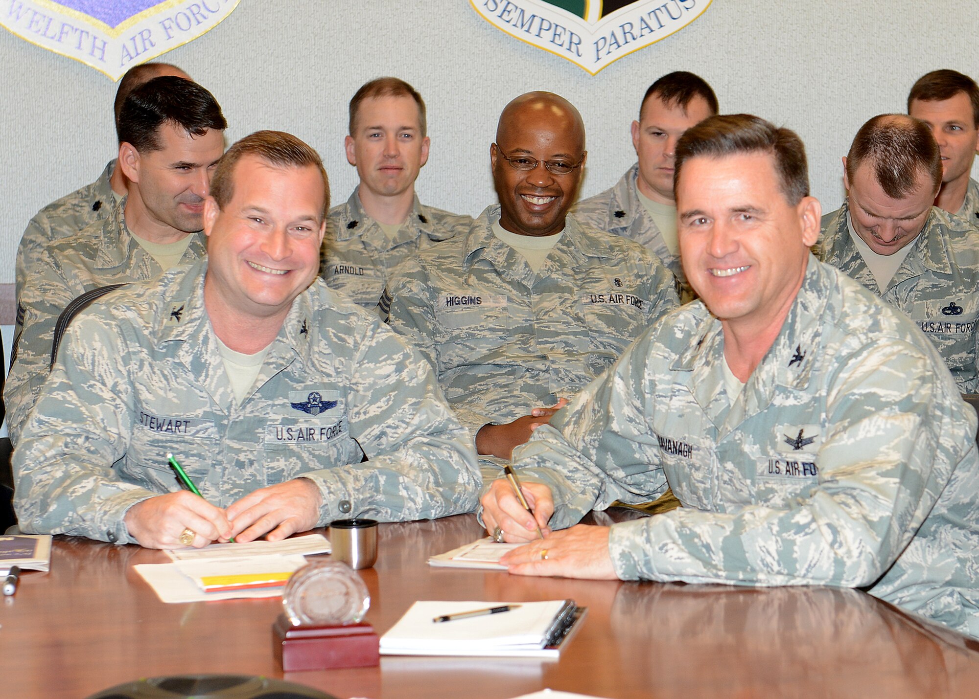 Col. Phil Stewart (left), 9th Reconnaissance Wing commander, and Col. Kevin Cavanagh, 940th Reserve Wing commander, sign their Combined Federal Campaign donations to kick off this year’s CFC drive. CFC has raised more than $7 Billion for charities, which range from local food pantries to international aid organizations. (U.S. Air Force photo by John Schwab/Released)        