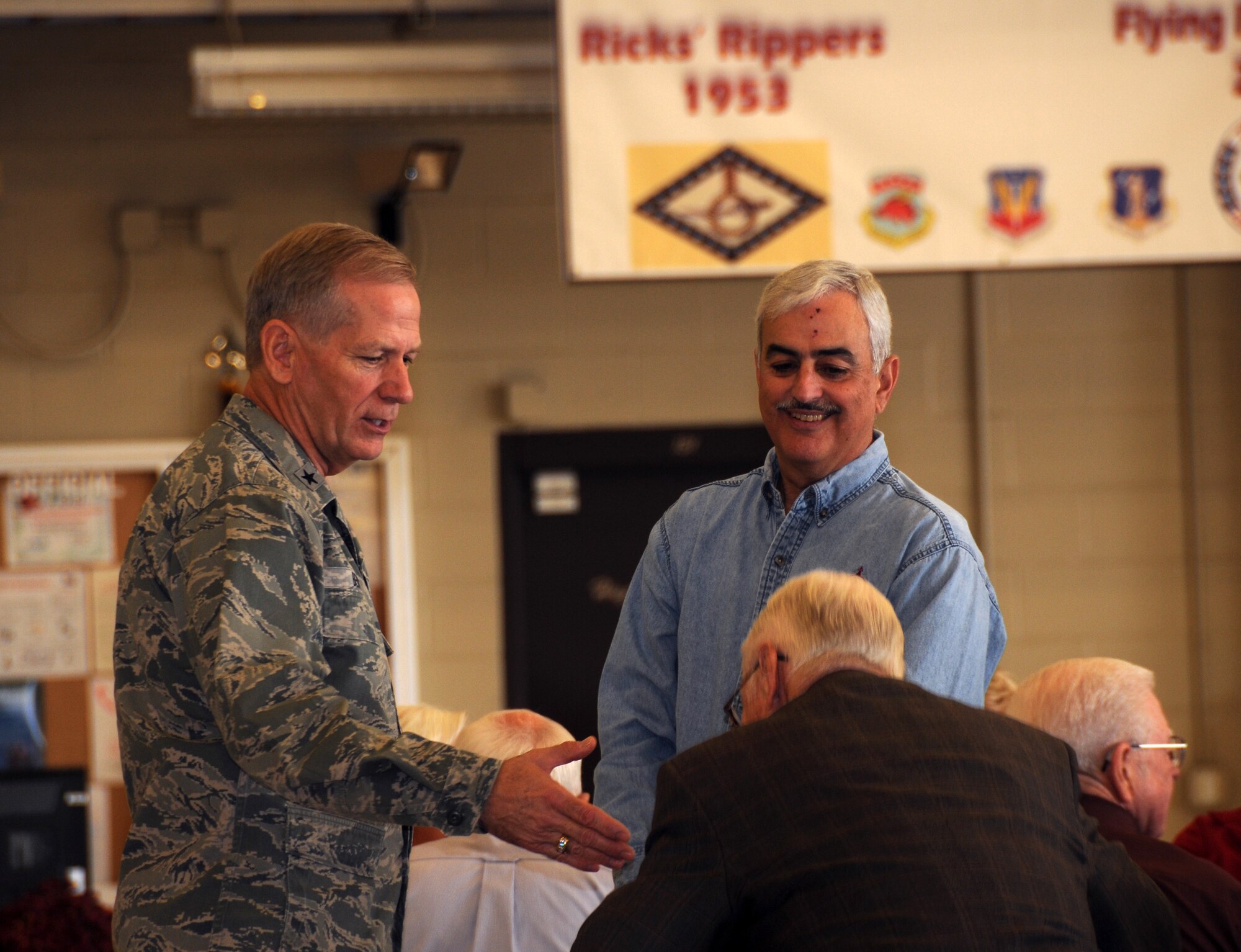 Brig. Gen. Mark Berry, Arkansas Air National Guard Chief of Staff, shakes hands with former 188th Fighter Wing members during the wing’s 60th anniversary jubilee Nov. 2, 2013 at the unit’s Ebbing Air National Guard Base, Fort Smith, Ark. Berry, also a former 188th member, made history at the 188th in 2012 by becoming the first general officer promoted from the 188th in more than 25 years. The 188th hosted the event in its main hangar to celebrate 60 years of excellence. The 188th marked 60 years as an Air National Guard unit Oct. 15. The unit began as the 184th Tactical Reconnaissance Squadron in 1953. More than 1,000 people attended the event. (U.S. Air National Guard photo by Senior Airman John Hillier/188th Fighter Wing Public Affairs)