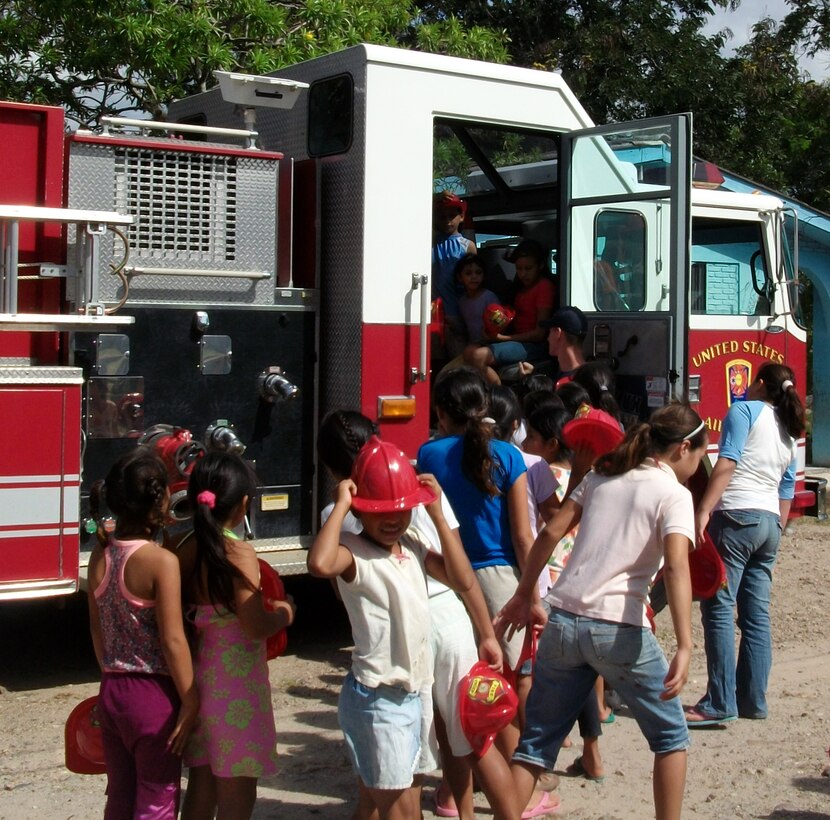 Children at the Nuestra Seniora de Guadalupe orphanage in Comayagua, Honduras, take a tour of a 612th Air Base Squadron fire truck, Nov. 6, 2013.  Twenty-one members of the 612 ABS spent the afternoon at orphanage.  Six children at the orphanage had a birthday during the month of November, and the 612 ABS members brought along birthday gifts to celebrate the occassion.  Members of the 612th spent the afternoon playing and visiting with the children.  (U.S. Air Force photo by Tech. Sgt. Stacy Rogers)