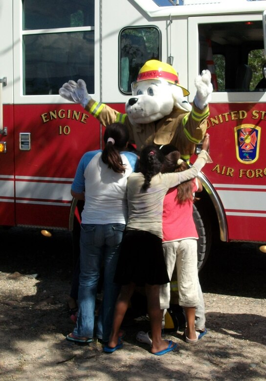 Sparky the Fire Dog greets children at the Nuestra Seniora de Guadalupe orphanage in Comayagua, Honduras, Nov. 6, 2013.  Twenty-one members of the 612 ABS spent the afternoon at orphanage.  Six children at the orphanage had a birthday during the month of November, and the 612 ABS members brought along birthday gifts to celebrate the occassion.  Members of the 612th spent the afternoon playing and visiting with the children.  (U.S. Air Force photo by Tech. Sgt. Stacy Rogers)