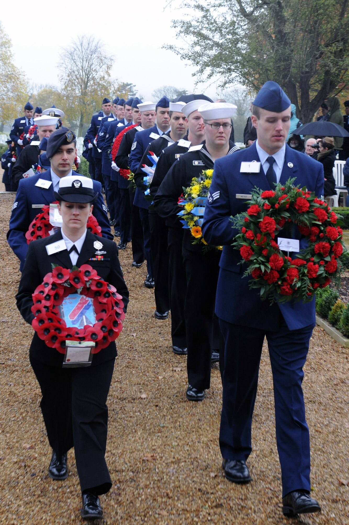 CAMBRIDGE, United Kingdom – Members of the 501st Combat Support Wing and its Mission Partners walk up to the base of the Tablets of the Missing in Cambridge American Cemetery, in Cambridge, United Kingdom, Nov. 11 during a Veterans Day ceremony. The ceremony honored the veterans of both the United States and United Kingdom. (U.S. Air Force photo by Staff Sgt. Brian Stives)