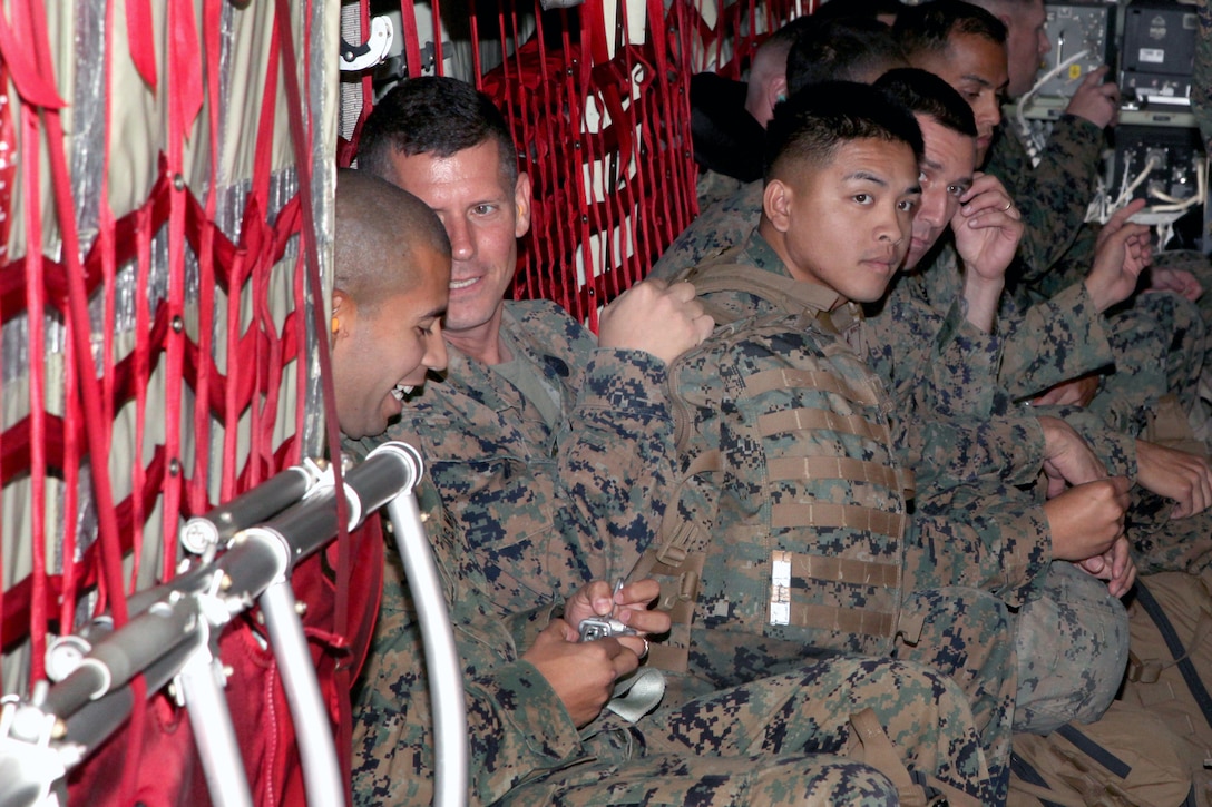 U.S. Marines and sailors deploy to the Phillippines aboard a KC-130J Hercules aircraft at Marine Corps Air Station Futenma, Okinawa, Japan, Nov. 11, 2013.  The Marines are assigned to the 3rd Expeditionary Force. 