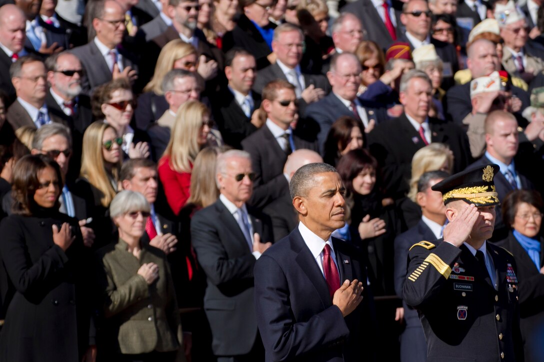 President Barack Obama and Maj. Gen. Jeffrey S. Buchanan, commanding general of, U.S. Army Military District of Washington, render honors during the playing of taps at the Tomb of the Unknowns during the Veterans Day ceremony at Arlington, Va., Nov. 11, 2013.