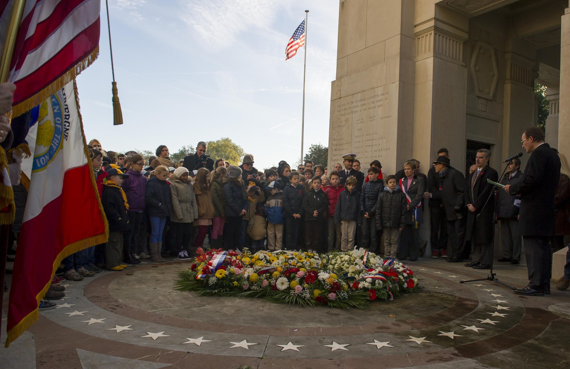 People listen to the closing remarks of a Veteran’s Day ceremony at the Lafayette Escadrille memorial in Marnes-la-Coquette, France Nov. 11, 2013. Lafayette Escadrille was a French Air Service squadron during World War I comprised largely of volunteer American fighter pilots.