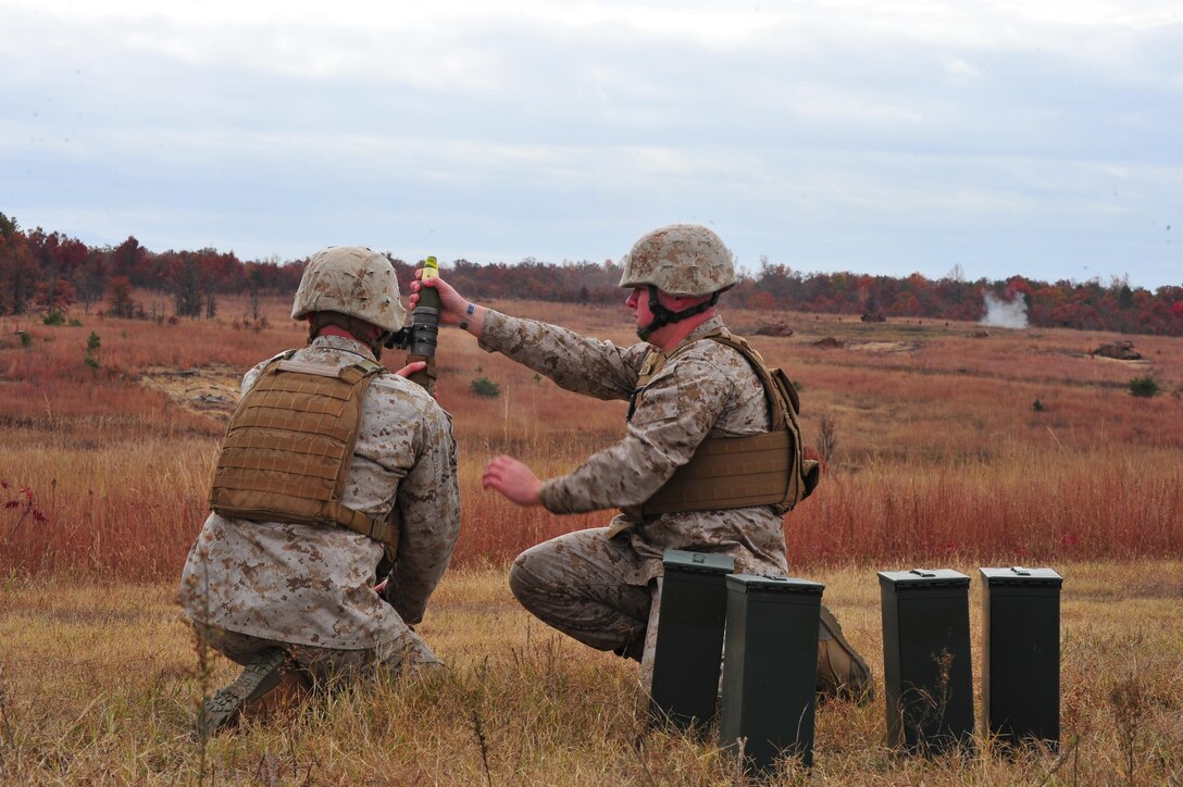 Sgt. Garrett Dennard, mortar assistant primary, Infantry Officer Course, and Cpl. Justine Auclair, mortar instructor, The Basic School Warfighting Instructor Company, demonstrates the use of a new concept sight for the M224 60mm mortar at Range 15, on Nov. 5, 2013. The new sights are created by the TechSolutions branch of the Office of Naval Research, in Arlington, Va.