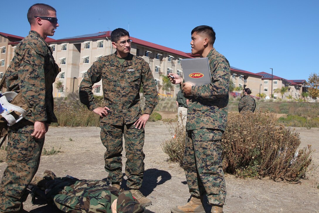 Petty Officer 2nd Class Peter Lam, right, a Navy tactical readiness training instructor with Combat Logistics Regiment 17, 1st Marine Logistics Group, teaches lifesaving scenarios during a combat lifesaver course aboard Camp Pendleton, Calif., Nov. 6, 2013. During the course, Marines and sailors learned vital techniques such as providing CPR, treating injuries like sucking chest wounds and applying tourniquets.