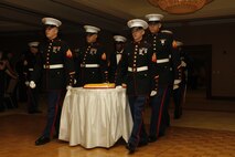 Members of Recruiting Station Kansas City's cake detail march in with the birthday cake during the 238th Marine Corps birthday ball into the Argosy Hotel and Casino ballroom Nov. 8, 2013. The guest speaker for the ball was retired Air Force Lt. Col. Barry B. Bridger, a former F-4 Phantom and Vietnam POW, who commented on his experiences as a POW during the war.
