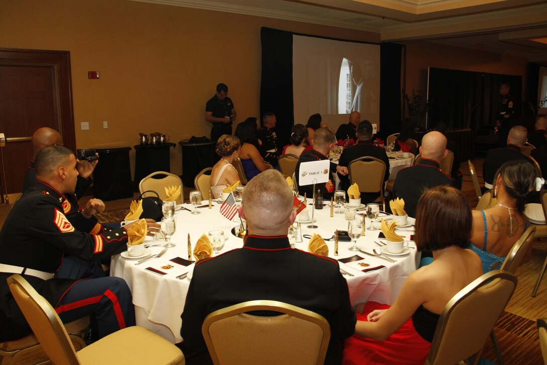 Marines and their guests look on as Gen. John Amos', commandant of the Marine Corps, birthday video message plays during the 238th Marine Corps birthday celebration at the Argosy Hotel and casino ballroom Nov. 8, 2013. The guest speaker for the ball was retired Air Force Lt. Col. Barry B. Bridger, a former F-4 Phantom and Vietnam POW, who commented on his experiences as a POW during the war.