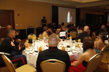Marines and their guests look on as Gen. John Amos', commandant of the Marine Corps, birthday video message plays during the 238th Marine Corps birthday celebration at the Argosy Hotel and casino ballroom Nov. 8, 2013. The guest speaker for the ball was retired Air Force Lt. Col. Barry B. Bridger, a former F-4 Phantom and Vietnam POW, who commented on his experiences as a POW during the war.