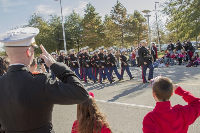 Virginia Beach, Va. (Nov. 11, 2013) –Col. Paul Ryan, commanding officer, Headquarters and Service Battalion, U.S. Marine Corps Forces Command, salutes the colors as they pass the reviewing stands during the Virginia Beach Veterans Day Parade Nov. 11. A parade has been held in Virginia Beach each year for more than 40 years. This year HQSVBN provided a color guard and parching platoon to represent the Marine Corps.