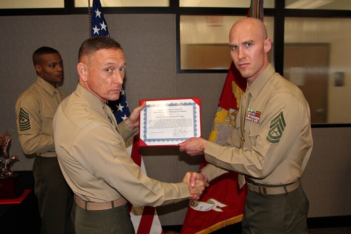 Gunnery Sgt. Raymond Jentz (right) accepts the Eugene M. Stoner Award from Brig. Gen. Frank Kelley, commander of Marine Corps Systems Command, Nov. 4 on Hospital Point at Marine Corps Base Quantico, Va. Jentz is a project officer for the Radio Reconnaissance Equipment Program in MCSC’s Marine Intelligence. The Stoner Award is presented to a Marine Corps staff noncommissioned officer for superior professional excellence and innovation in pursuit of the acquisition, fielding and support of systems and equipment to the operating forces. 