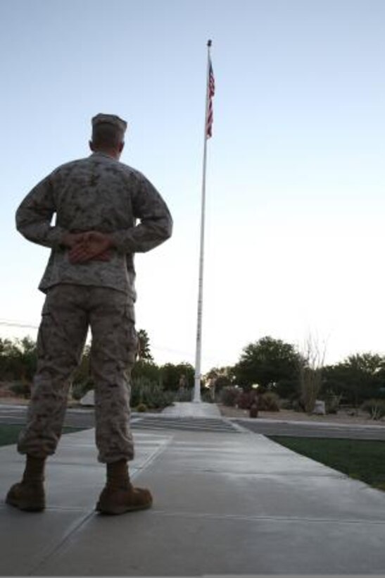 Lance Corporal William Kirk, customer support technician on Marine Corps Logistics Base Barstow, Calif., stands by for the playing of colors, Oct. 22, here.


