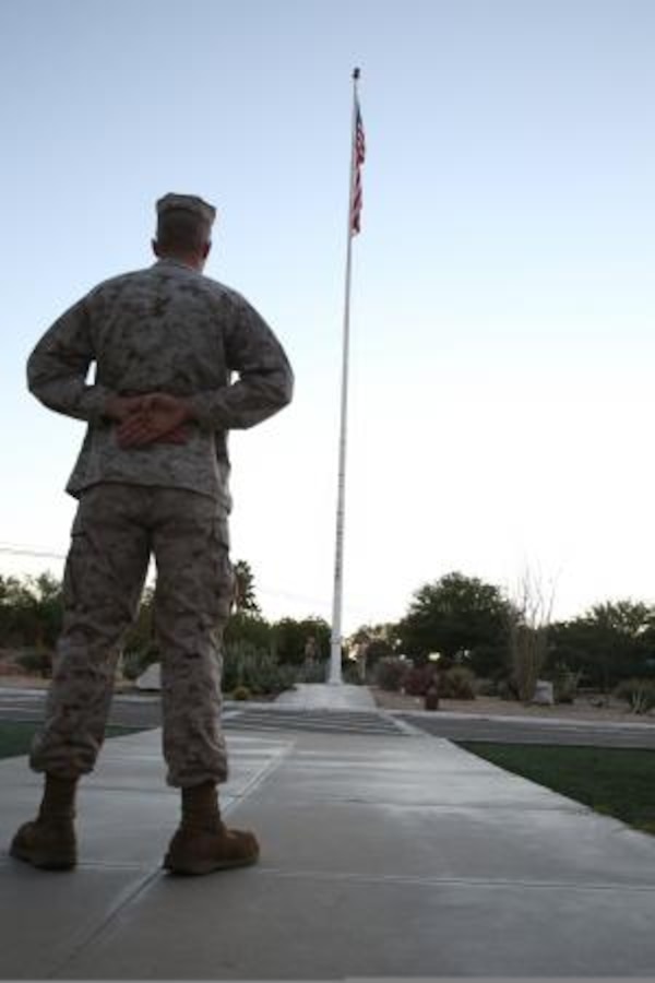 Lance Corporal William Kirk, customer support technician on Marine Corps Logistics Base Barstow, Calif., stands by for the playing of colors, Oct. 22, here.



