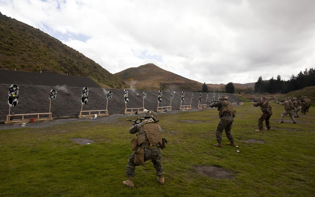 Members of a personal protection team assess and fire upon their targets during a familiarization shooting range with the Individual Weapon (IW) Steyr assault rifle during the initial stages of exercise Southern Katipo 2013 at Waiouru Military Camp, New Zealand, Nov. 7. SK13 strengthens military to military relationships and cooperation with partner nations and the New Zealand Defence Force.