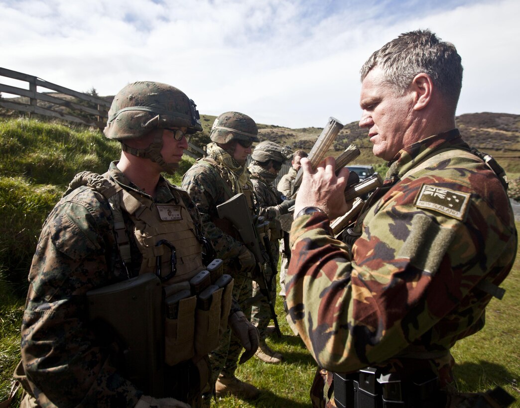 New Zealand Defence Force Sgt. Geoff Brown, personal protection officer, Military Police, inspects members of a personal protection team prior to a familiarization shooting range with the Individual Weapon (IW) Steyr assault rifle during the initial stages of exercise Southern Katipo 2013 at Waiouru Military Camp, New Zealand, Nov. 7. SK13 strengthens military to military relationships and cooperation with partner nations and the NZDF. Brown is from Wellington, New Zealand.