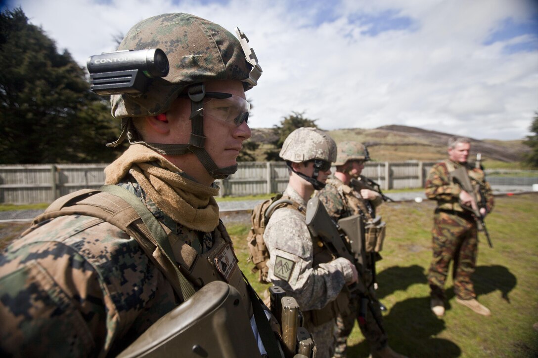 Cpl. Thomas Cornwall, military policeman with 1st Law Enforcement Battalion, from Ventura, Calif., and other members of a personal protection team receive a safety brief prior to a familiarization shooting range with the Individual Weapon (IW) Steyr assault rifle during the initial stages of exercise Southern Katipo 2013 at Waiouru Military Camp, New Zealand, Nov. 7. SK13 increases the ability of all participants to coordinate in complex situations.   