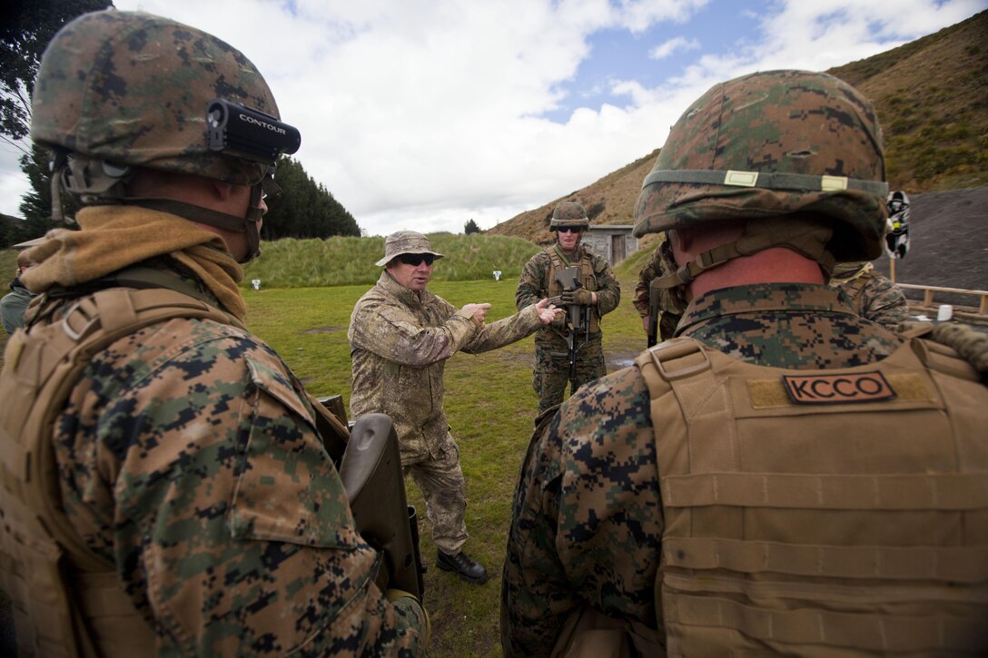 Warrant Officer 1 Percy McLaughlin, warrant officer for Headquarters Deployable Joint Inter-Agency Task Force, New Zealand Defence Force, shows shooting techniques to members of a personal protection team during to a familiarization shooting range with the Individual Weapon (IW) Steyr assault rifle during the initial stages of exercise Southern Katipo 2013 at Waiouru Military Camp, New Zealand, Nov. 7. SK13 increases the ability of all participants to coordinate in complex situations.   