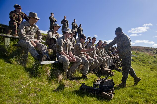 Sgt. Patrique Fearon, combat engineer for 1st Combat Engineer Battalion, from Hartford, Conn., passes around examples of improvised explosive devices to New Zealand and Papua New Guinean engineers at combat hunter training during the initial stages of exercise Southern Katipo 2013 aboard Waiouru Military Camp, New Zealand, Nov. 9. Working alongside our regional allies builds strong multinational relationships, expands interoperability and increases preparedness for contingency operations. 