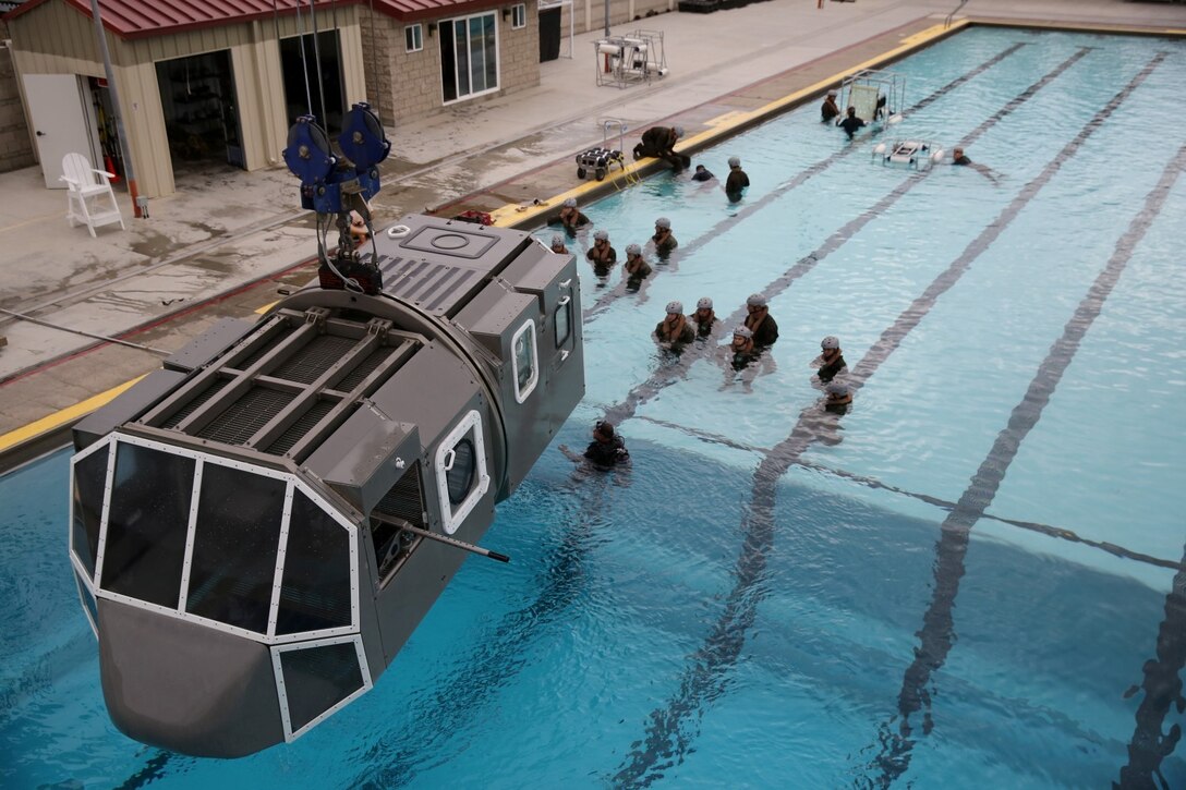 Marines with 2nd Battalion, 5th Marine Regiment, prepare to board a Modular Amphibious Egress Trainer during a helicopter dunker exercise here, Nov. 4, 2013. The training is designed to teach Marines how to egress from a helicopter in the event it crashes in open waters. The Marines conducted the training as preparation for their upcoming deployment with the 31st Marine Expeditionary Unit.