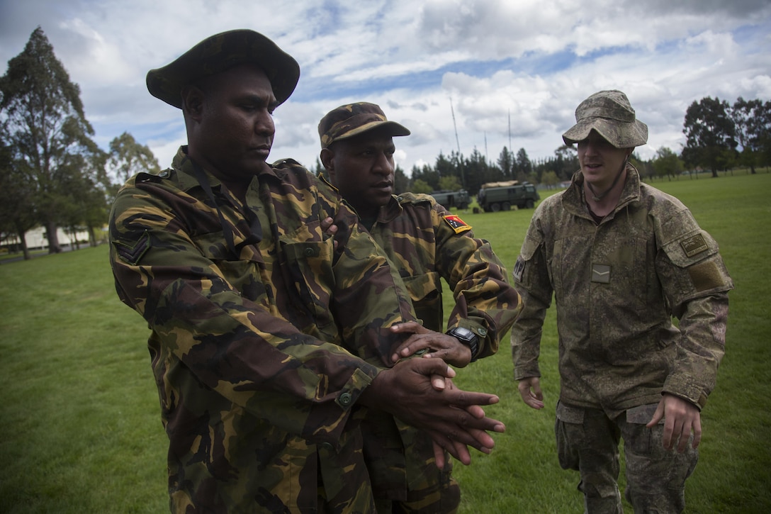 New Zealand Army Lance Cpl. Martin Murdoch, right, a military policeman with 1st New Zealand Military Police Company, instructs Papua New Guinean soldiers on detainee handling procedures during the initial phase of exercise Southern Katipo 2013 (SK13) on Waiouru Military Camp, New Zealand, Nov. 7. SK13 is a New Zealand led training exercise to enhance interoperability between coalition forces and to help the New Zealand Defence Force further develop its amphibious capabilities.