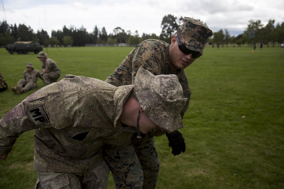 Cpl. Israel Ponce, a military policeman with 1st Law Enforcement Battalion, instructs a New Zealand Army soldier on restraining procedures for an uncooperative detainee during the initial phase of exercise Southern Katipo 2013 (SK13) on Waiouru Military Camp, New Zealand, Nov. 7. SK13 is a New Zealand led training exercise to enhance interoperability between coalition forces and to help the New Zealand Defence Force further develop its amphibious capabilities.