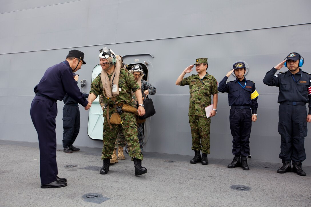 Lt. Gen. Koichiro Bansho prepares to embark on an MV-22B Osprey and return to Marine Corps Air Station Futenma in Okinawa Nov. 12 aboard the Japan Maritime Self-Defense Force ship Ise. This marks the first time the Osprey landed aboard a JMSDF ship in the Asia-Pacific region, as well as the first time that Bansho has flown on an Osprey. Bansho is the commanding general of the Western Army, Japan Ground Self-Defense Forces. The Osprey is with Marine Medium Tiltrotor Squadron 265, 1st Marine Aircraft Wing, III Marine Expeditionary Force, currently assigned to the 31st Marine Expeditionary Unit. (U.S. Marine Corps photo by Lance Cpl. Matthew S. Myers/Released)