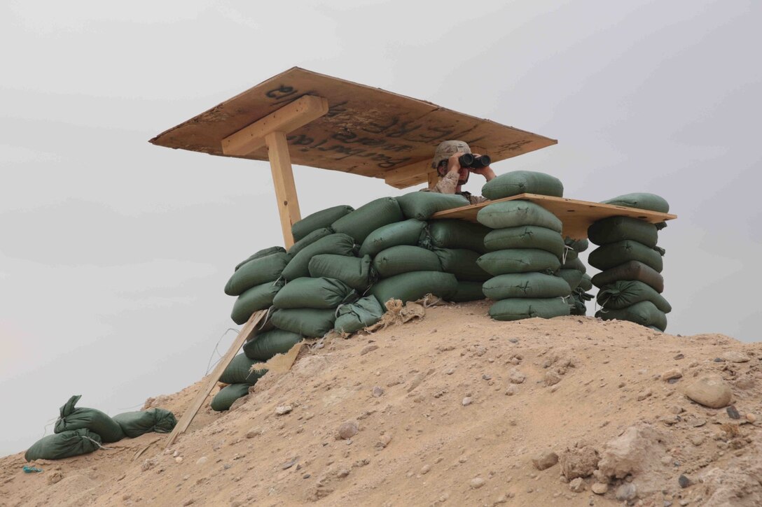 CAMP BUEHRING, KUWAIT (Nov. 1, 2013)A U.S. Marine with 13th Marine Expeditionary Unit stands watch at a post aboard Camp Buehring, Kuwait Nov. 1, 2013. The 13th MEU is deployed with the Boxer Amphibious Ready Group as a theater reserve and crisis response force throughout the U.S. 5th Fleet area of responsibility. (U.S. Marine Corps photo by Cpl. David Gonzalez, 13th Marine Expeditionary Unit Combat Camera/Released)