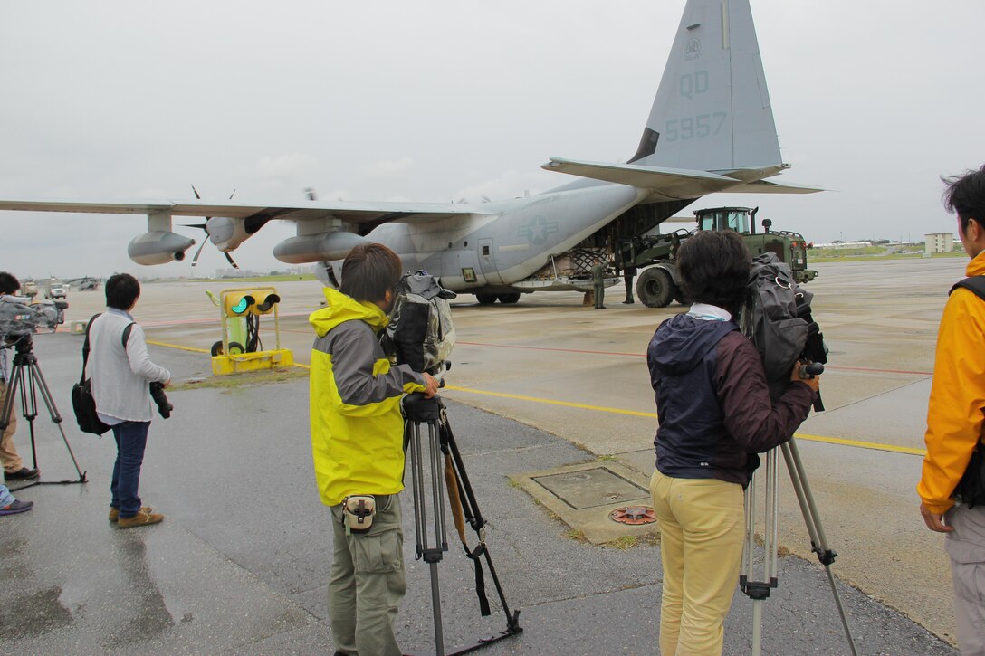 Japanese Media film Marines and Sailors of 3rd Marine Expeditionary Brigade, III Marine Expeditionary Force, as they prepare to depart in a KC-130J Hercules aircraft Nov. 12 on Marine Corps Air Station Futenma, Okinawa, Japan. Marines and Sailors from the 3rd MEB are deploying to the Philippines to support humanitarian assistance and disaster relief operations in the wake of typhoon Haiyan. At the request of the Government of the Philippines, Secretary of Defense Chuck Hagel has directed U.S. Pacific Command to support U.S. Government HADR operations in the Philippines. To date, approximately 300 personnel from 3rd MEB have deployed to the Philippines to support the HADR operations. The aircraft is with Marine Aerial Refueler Transport Squadron 152, Marine Aircraft Group 36, 1st Marine Aircraft Wing, III Marine Expeditionary Force. 