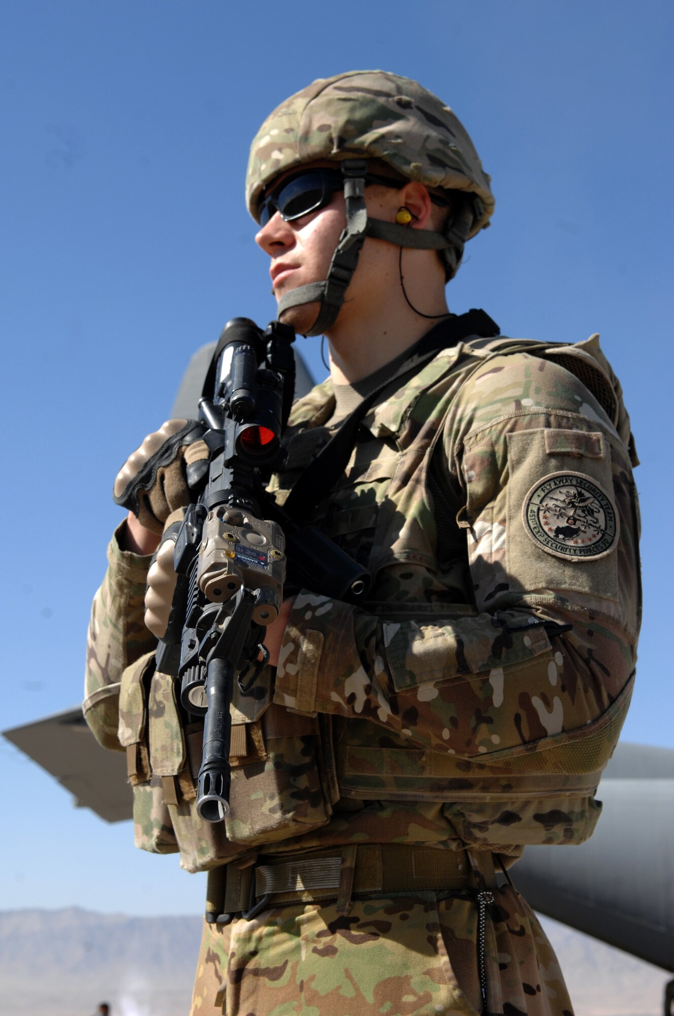 Senior Airman Andrew Beer, 451st Expeditionary Security Forces Squadron Fly Away Security Team, provides over-watch security for a C-130J Hercules during a mission in Southwest Asia, Nov. 2, 2013. FAST members provide security for aircraft and crews in locations where little to no security assets are available. (U.S. Air Force photo by Senior Airman Jack Sanders)