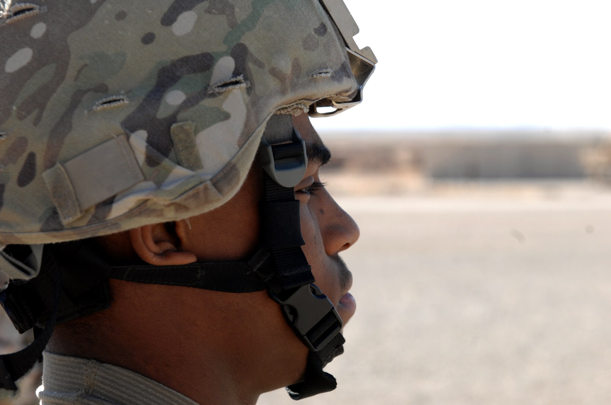 Airman 1st Class Deon Ware, 451st Expedition Security Forces Squadron Fly Away Security Team, scans the surrounding area for threats during over-watch security of a C-130J Hercules on a mission in Southwest Asia, Nov. 2, 2013. FAST members provide security for aircraft and crews in locations where little to no security assets are available. (U.S. Air Force photo by Senior Airman Jack Sanders)