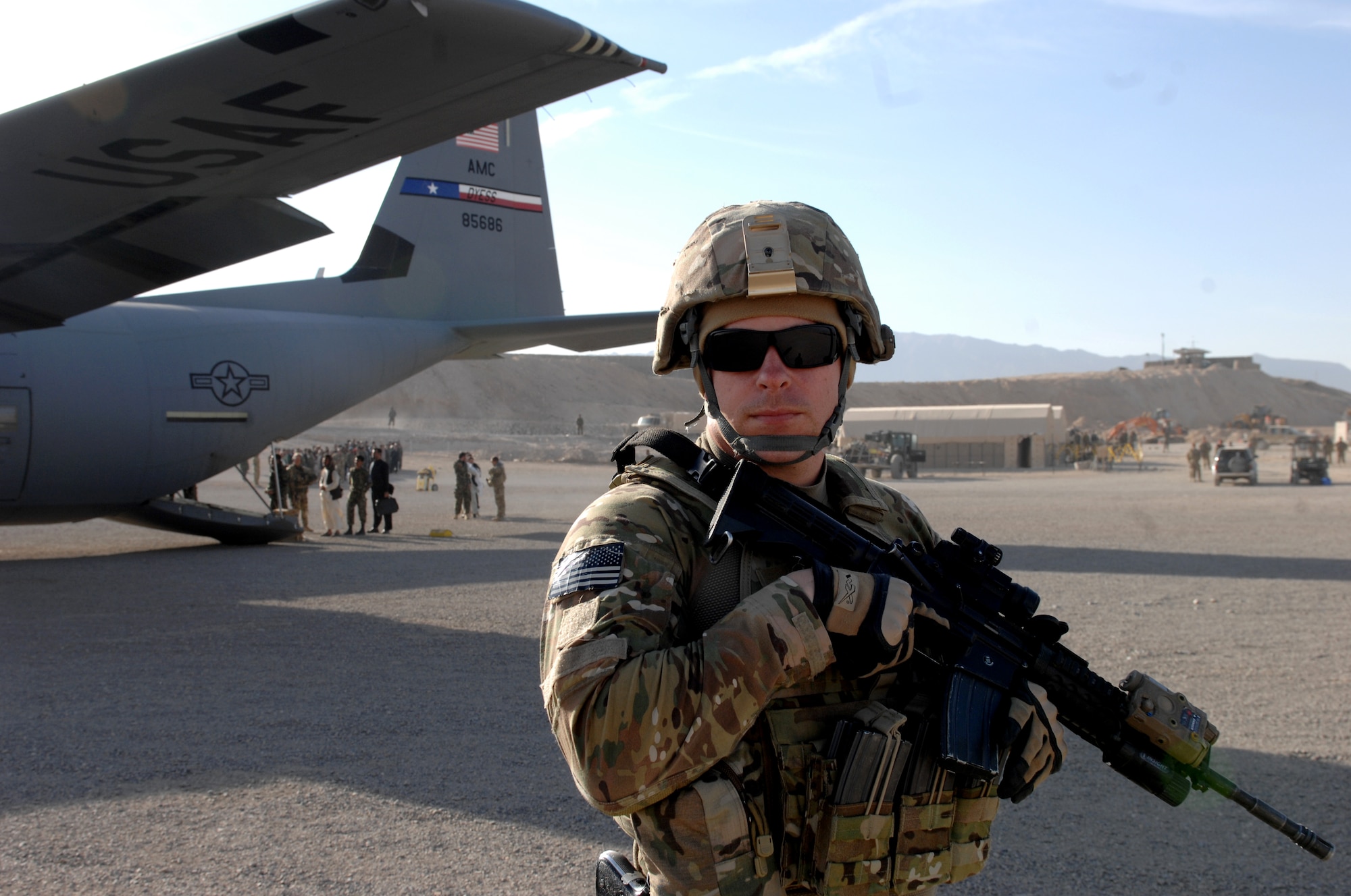 Staff Sgt. Steve McCoy, 451st Expeditionary Security Forces Squadron Fly Away Security Team, provides over-watch security for a C-130J Hercules during a mission in Southwest Asia, Nov. 2, 2013. FAST members provide security for aircraft and crews in locations where little to no security assets are available. (U.S. Air Force photo by Senior Airman Jack Sanders)
