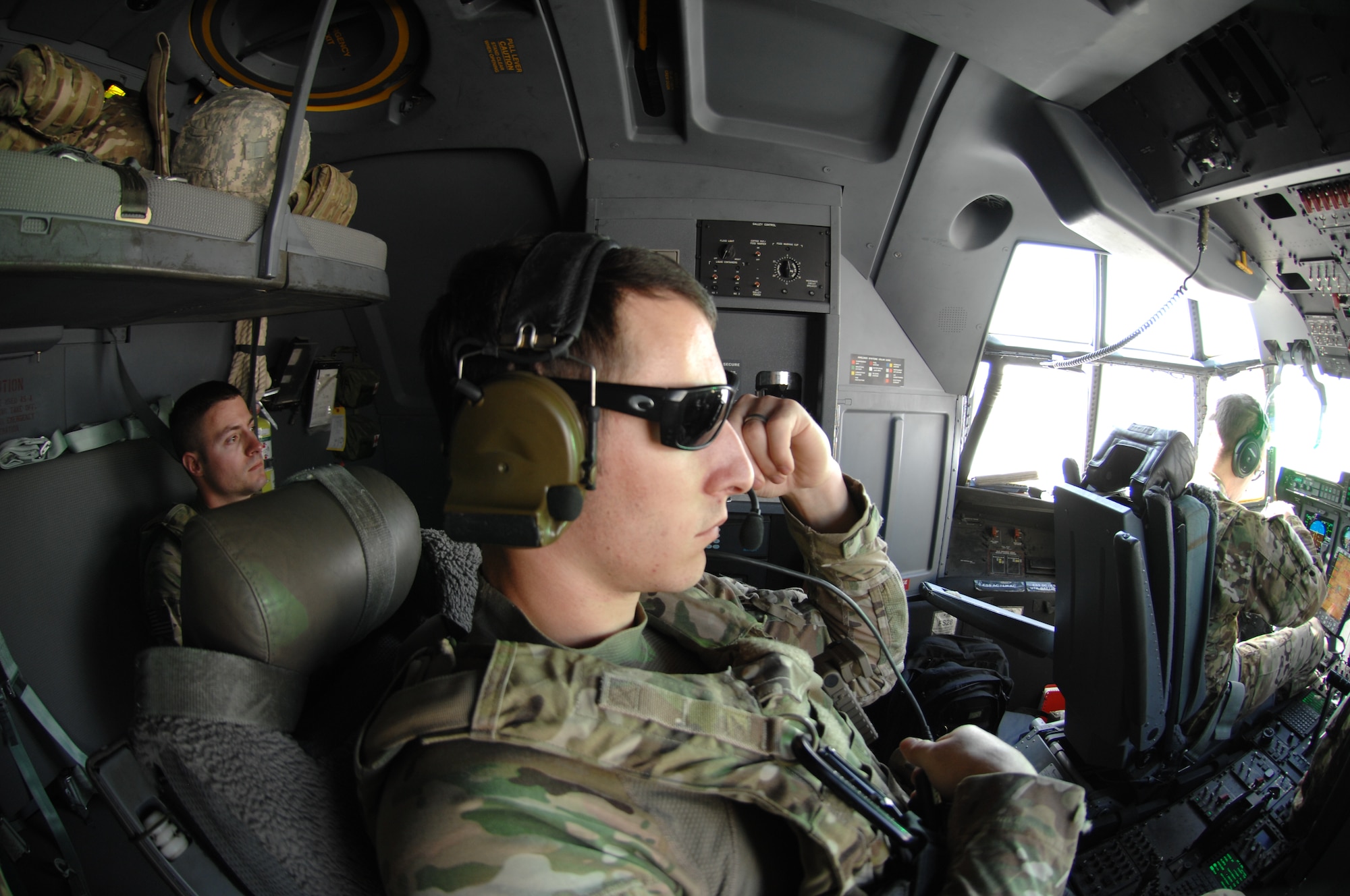 Airman 1st Class Nicholas Portieri, 451st Expeditionary Security Forces Squadron Fly Away Security Team, listens to pilots while providing flight deck denial security Oct. 26, 2013. Providing flight deck denial security is one of the requirements for FAST members. (U.S. Air Force photo by Senior Airman Jack Sanders)