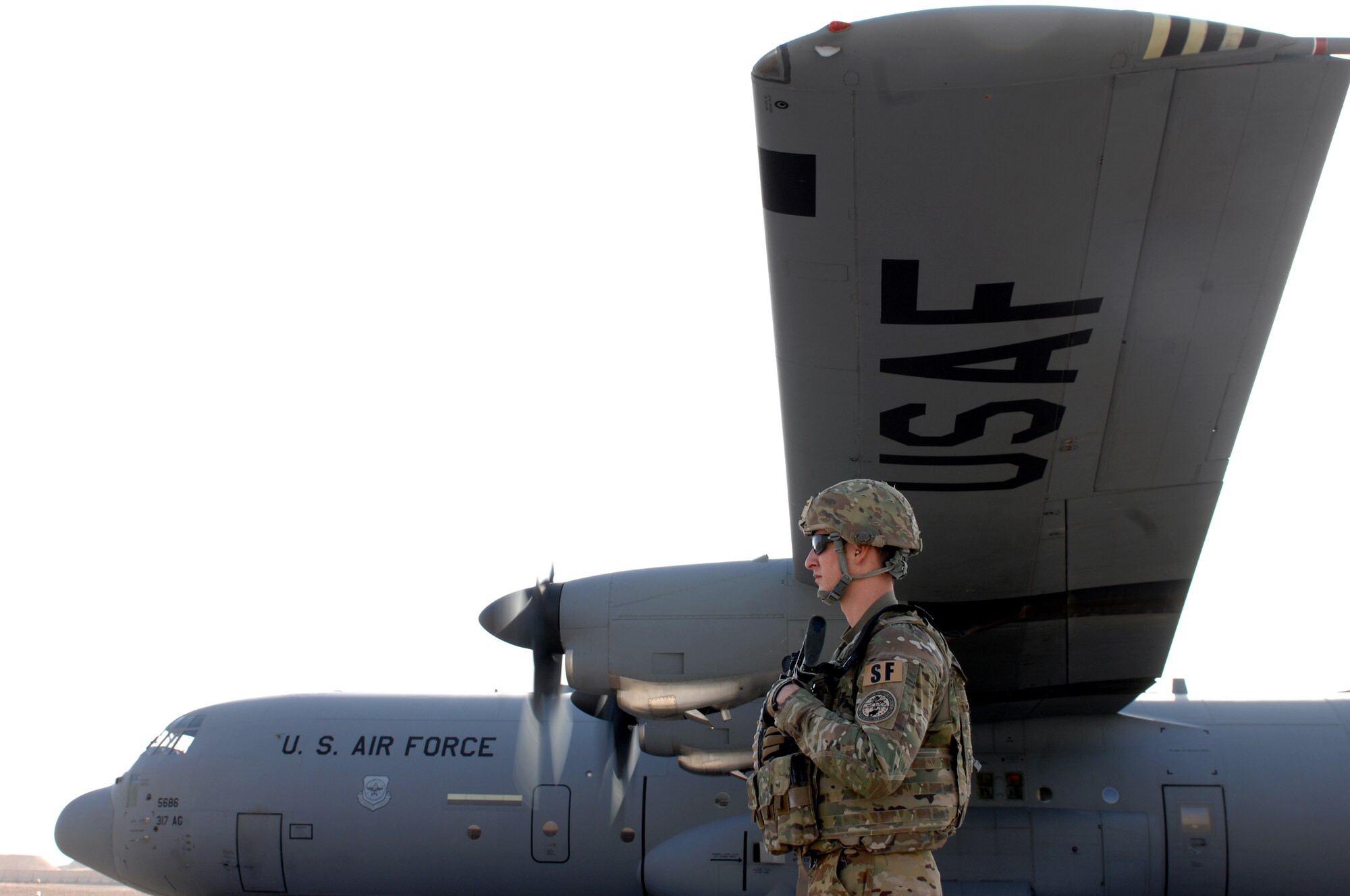 Airman 1st Class Nicholas Portieri, 451st Expeditionary Security Forces Squadron Fly Away Security Team, stands guard of a C-130J Hercules at an undisclosed location in Southwest Asia, Oct. 26, 2013. FAST members provide security for aircraft and crews in locations where little to no security assets are available. (U.S. Air Force photo by Senior Airman Jack Sanders)