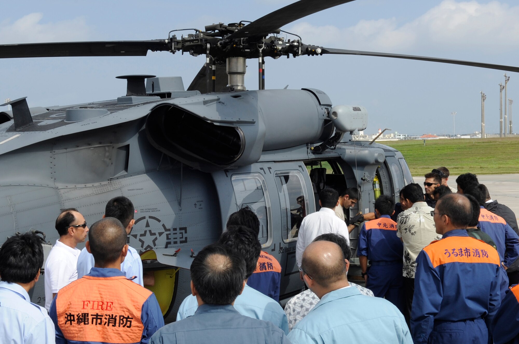 More than 35 local emergency first responders receive emergency aircraft safety training from the 18th Civil Engineer Squadron firefighters at Kadena Air Base, Japan, Nov. 6, 2013. The training is held biannually as part of a 2008 agreement between the Japanese government and the U.S. military to protect Japanese and American lives. (U.S. Air Force photo by Senior Airman Marcus Morris)