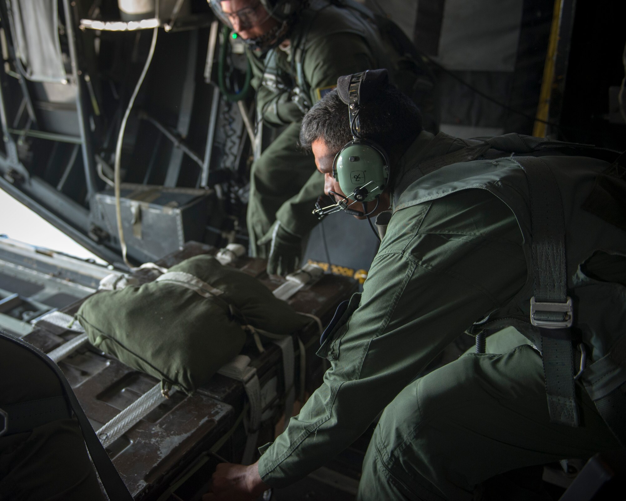 A Bangladesh Air Force loadmaster positions a Low-Cost, Low Altitude airdrop bundle aboard a U.S. Air Force C-130 Hercules during exercise Cope South at Bangabandhu Air Base, Bangladesh, Nov. 12, 2013. Airmen from Yokota Air Base, Japan, demonstrated Low-Cost, Low Altitude airdrop techniques during a subject-matter expert exchange designed to show Bangladeshi Airmen an effective and safe way to deliver supplies in a during disasters. (U.S. Air Force photo by Captain Raymond Geoffroy/Released)