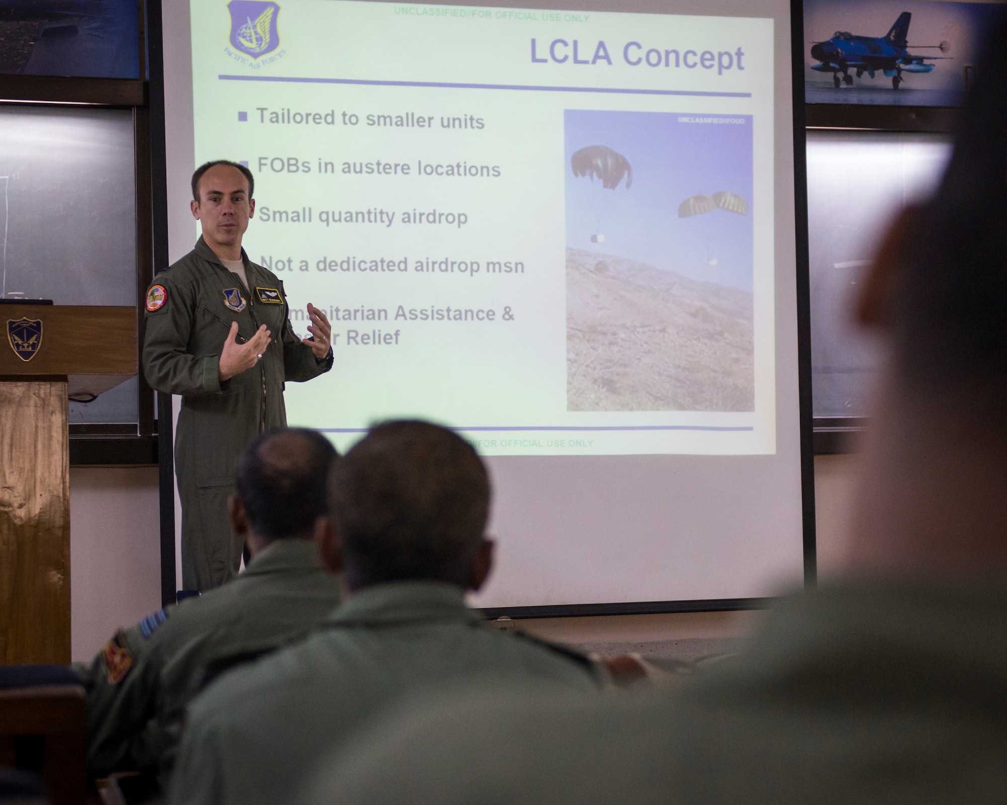 Captain Matt Deardorff, 36th Airlift Squadron pilot, describes Low-Cost, Low Altitude airdrop procedures to Bangladeshi Airmen during exercise Cope South at Bangabandhu Air Base, Bangladesh, Nov. 11, 2013. U.S. and Bangladeshi Airmen exchanged airdrop techniques during subject-matter expert exchanges to improve their mutual airlift capabilities. (U.S. Air Force photo by Captain Raymond Geoffroy/Released)