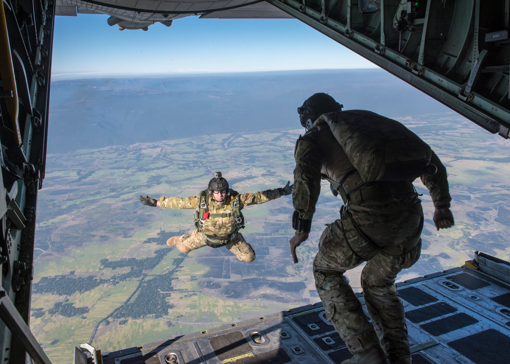 U.S. Airmen jump from a C-130 Hercules during exercise Cope South over Bangladesh, Nov. 10, 2013. Approximately 80 U.S. Airmen and 3 C-130s are teaming up with Bangladeshi Airmen to exchange airlift expertise through a series of missions and subject-matter expert exchanges. (U.S. Air Force photo by Captain Raymond Geoffroy/Released)