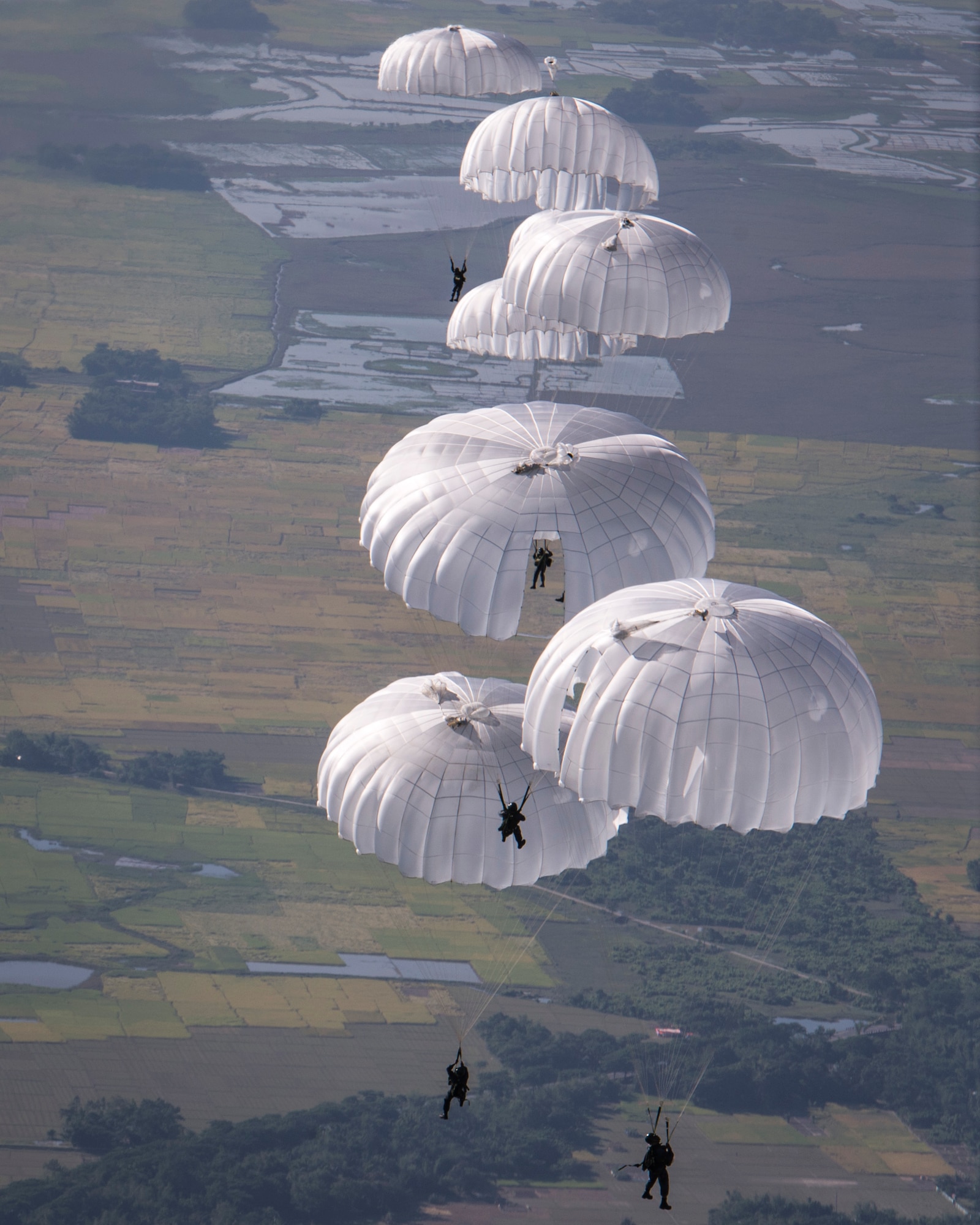 Bangladeshi paratroopers jump from a U.S. C-130 Hercules during exercise Cope South over Bangladesh, Nov. 10, 2013. Cope South is designed to provide Bangladeshi and U.S. forces the opportunity to strengthen relations and promote interoperability. (U.S. Air Force photo by Captain Raymond Geoffroy/Released)